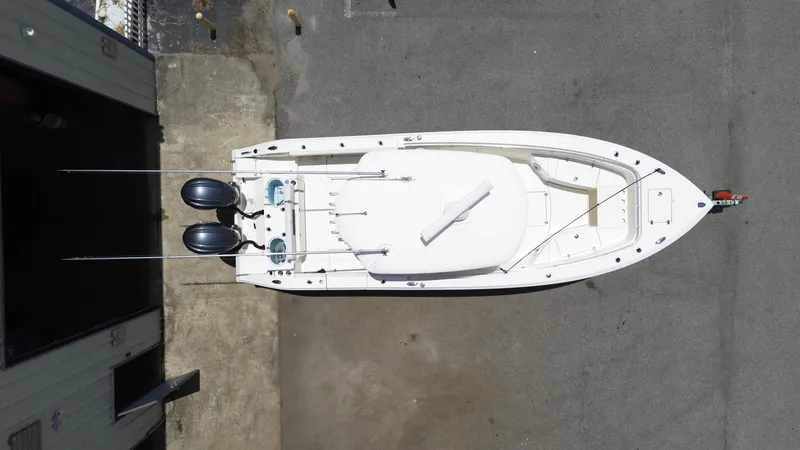 Slide: The Image of 2022 Cobia 301 Center Console boat, aerial view, docked with dual outboard motors. - 28