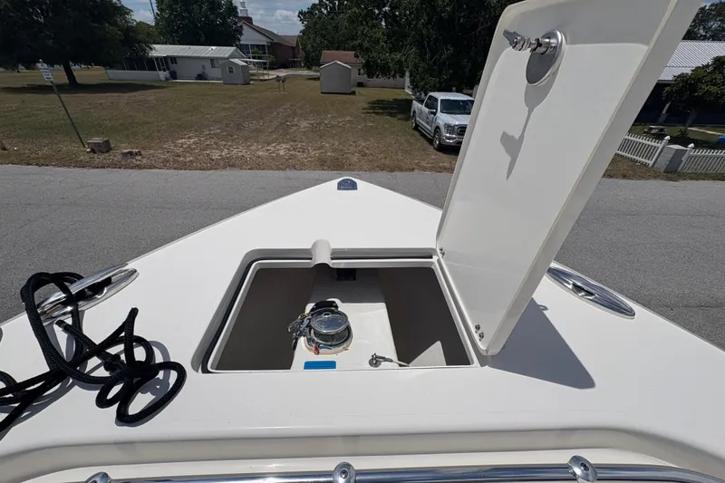 Slide: The Image of 2022 Cobia 301 Center Console boat with open storage compartment on deck. - 38