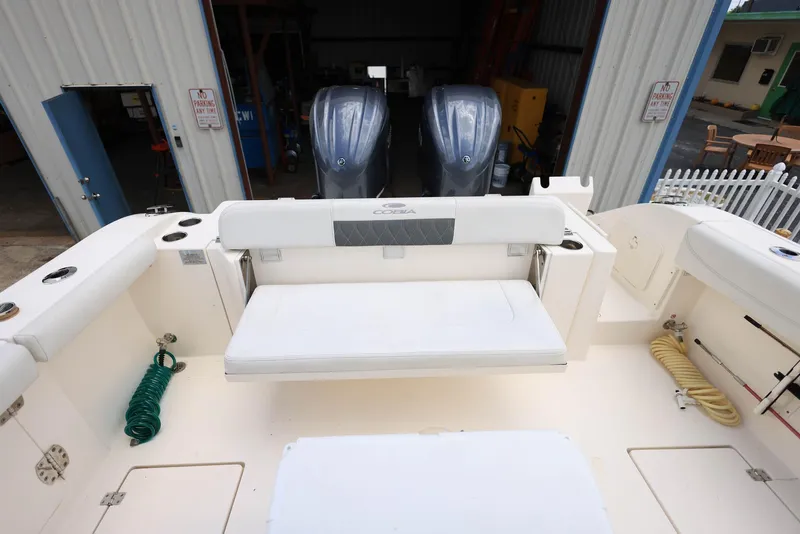 Slide: The Image of 2022 Cobia 301 Center Console boat with dual engines and spacious seating area. - 8
