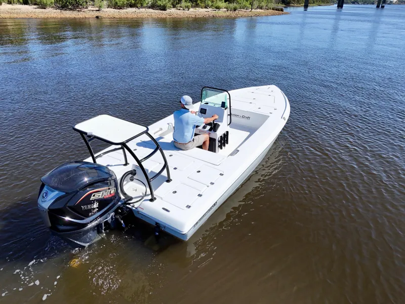 Slide: The Image of 2025 Action Craft 20 Flats boat on calm water, featuring a Yamaha engine. - 15