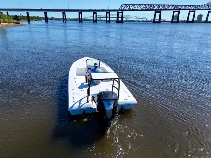 Slide: The Image of 2025 Action Craft 20 Flats boat on calm river near a bridge. - 17