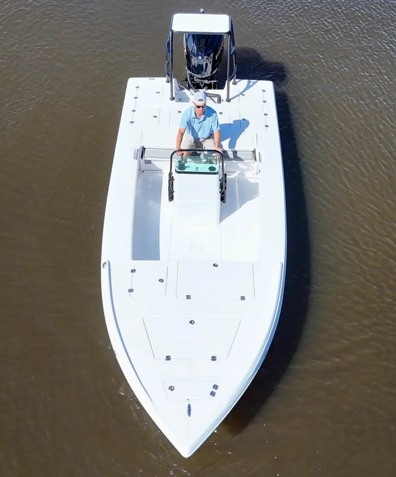 Slide: The Image of 2025 Action Craft 20 Flats boat on calm water, viewed from above. - 18