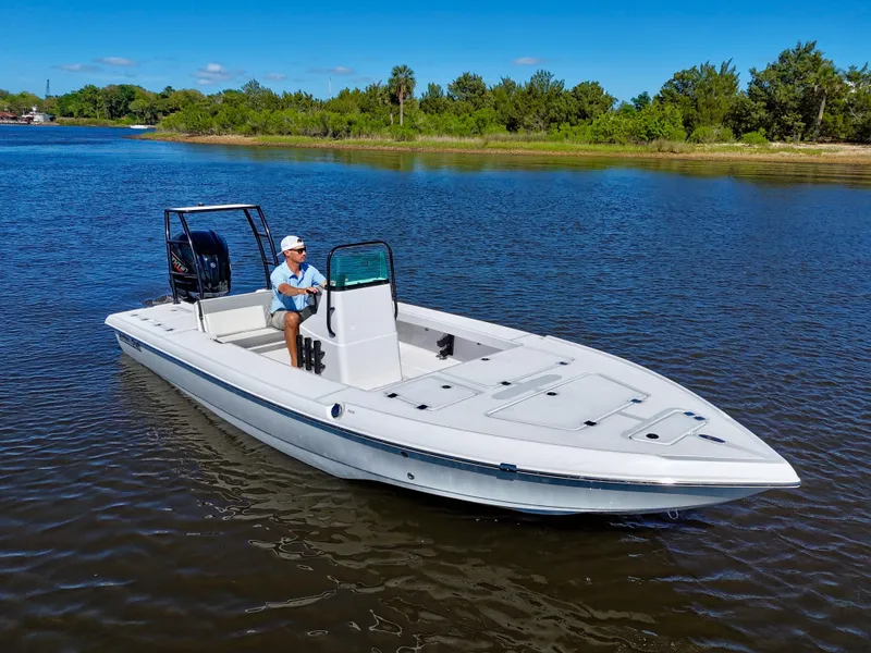 Slide: The Image of 2025 Action Craft 20 Flats boat on calm water, featuring sleek design and spacious deck. - 19