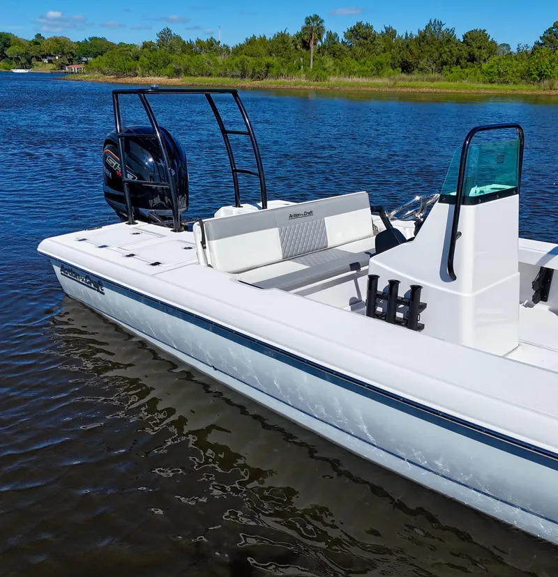 Slide: The Image of 2025 Action Craft 20 Flats boat on calm water, featuring sleek design and modern outboard motor. - 21