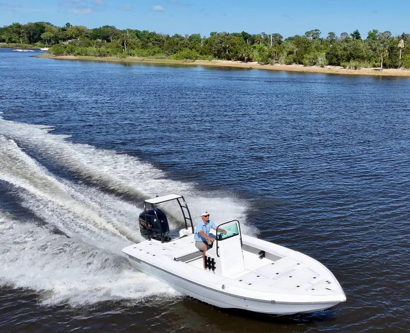 Slide: The Image of 2025 Action Craft 20 Flats boat cruising on a scenic river. - 22