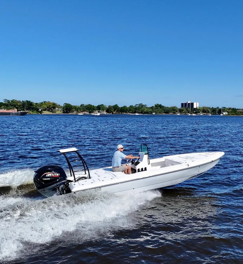 Slide: The Image of 2025 Action Craft 20 Flats boat cruising on a sunny day in open water. - 25