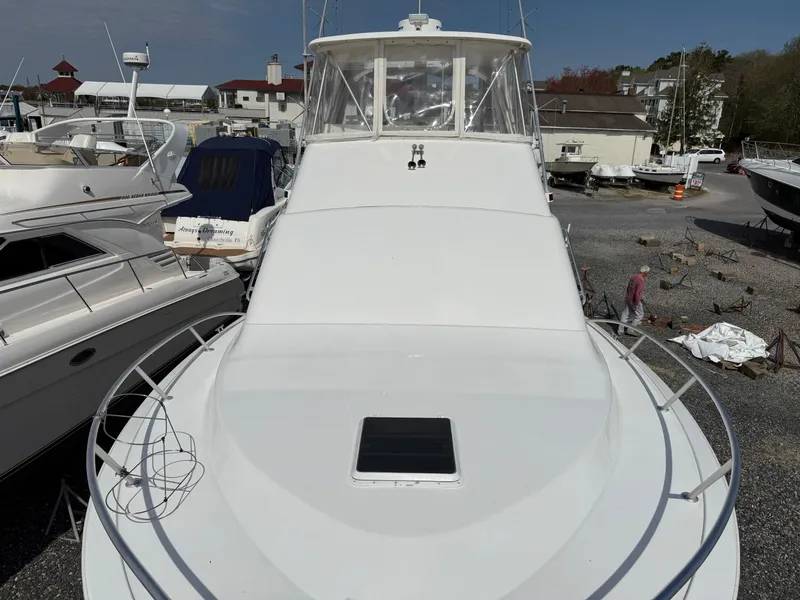 Slide: The Image of 1999 Ocean Yachts 40 Super Sport boat docked in a marina, viewed from the bow. - 16