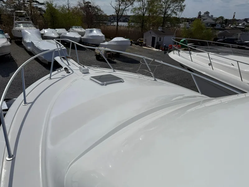 Slide: The Image of 1999 Ocean Yachts 40 Super Sport boat on display in a marina with other vessels. - 18