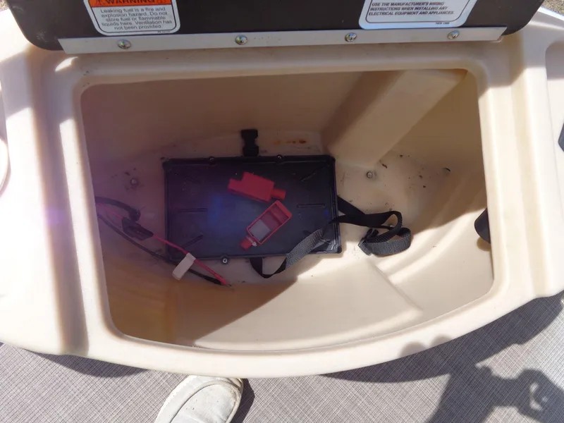 Slide: The Image of Open storage compartment in 2019 Sun Tracker Fishin' Barge 22 DLX boat. - 14