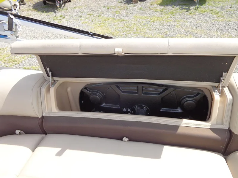 Slide: The Image of 2019 Sun Tracker Fishin' Barge 22 DLX storage compartment with open lid. - 23