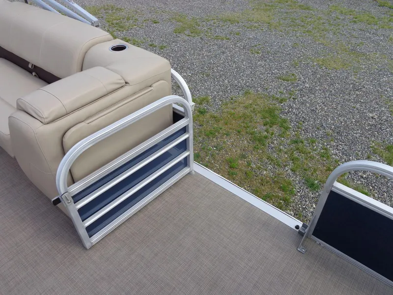 Slide: The Image of 2019 Sun Tracker Fishin' Barge 22 DLX interior with beige seating and aluminum railing. - 26