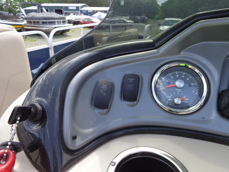Slide: The Image of Dashboard of 2019 Sun Tracker Fishin' Barge 22 DLX with RPM gauge and switches. - 35