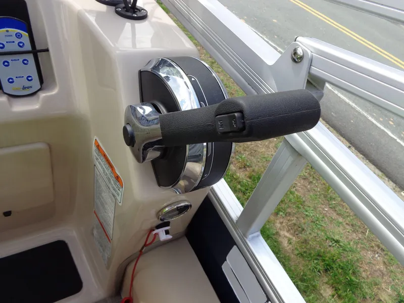 Slide: The Image of 2019 Sun Tracker Fishin' Barge 22 DLX throttle control on a beige console. - 36
