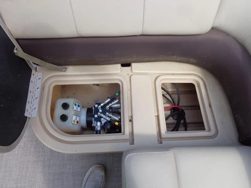 Slide: The Image of 2019 Sun Tracker Fishin' Barge 22 DLX storage compartment with hydraulic system and wiring. - 39
