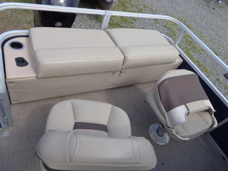 Slide: The Image of 2019 Sun Tracker Fishin' Barge 22 DLX interior with beige seating and cup holders. - 41