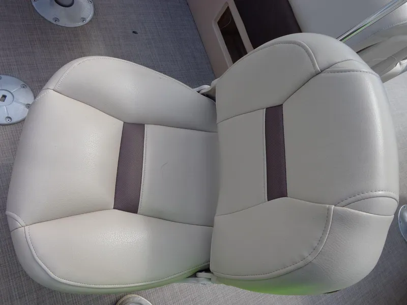 Slide: The Image of 2019 Sun Tracker Fishin' Barge 22 DLX boat seat, beige with dark accent, on textured flooring. - 42