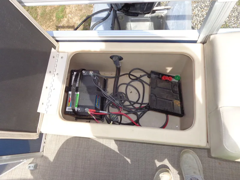 Slide: The Image of Battery compartment of 2019 Sun Tracker Fishin' Barge 22 DLX with wiring and cover. - 46