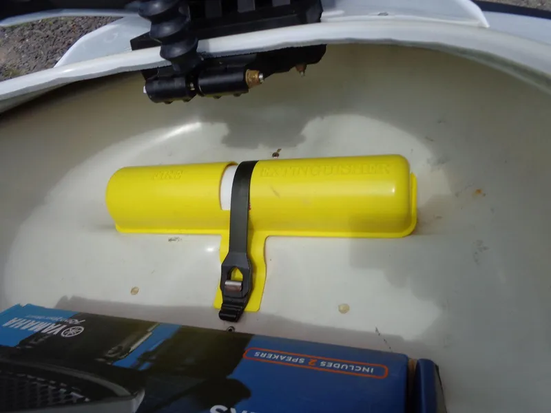 Slide: The Image of Storage compartment of 2019 Yamaha FX Cruiser HO with yellow fire extinguisher holder. - 29