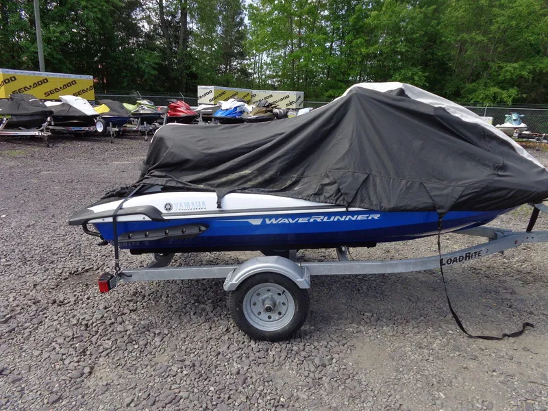 Slide: The Image of 2019 Yamaha FX Cruiser HO jet ski covered on a trailer in a lot. - 31