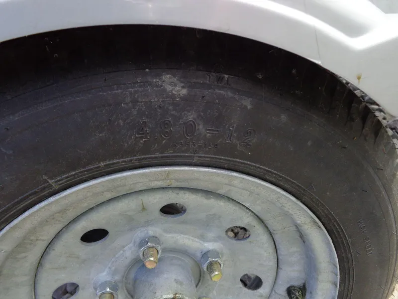 Slide: The Image of Close-up of a tire on a 2019 Yamaha Boats FX Cruiser HO trailer. - 36