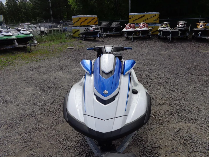 Slide: The Image of 2019 Yamaha FX Cruiser HO jet ski in a gravel lot, surrounded by other watercraft. - 4