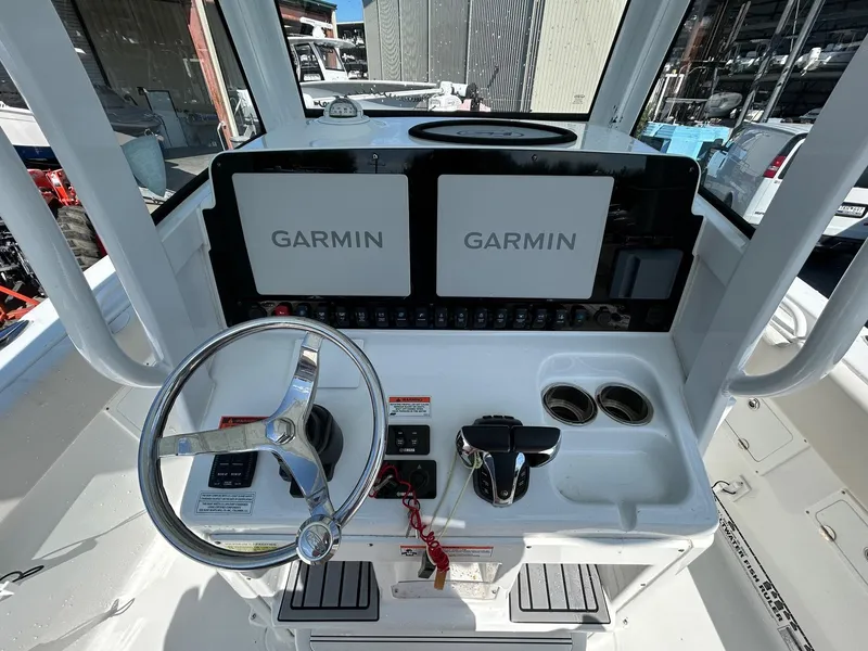 Slide: The Image of 2022 Sea Hunt Gamefish 25 helm with dual Garmin displays and steering wheel. - 10