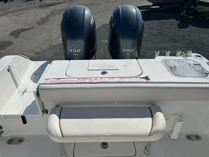 Slide: The Image of 2022 Sea Hunt Gamefish 25 boat with dual 150 horsepower engines, rear seating, and fishing amenities. - 13