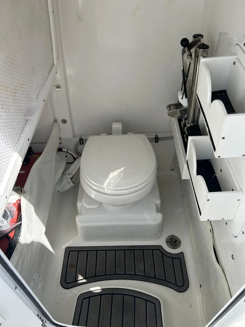 Slide: The Image of 2022 Sea Hunt Gamefish 25 boat interior with toilet and storage compartments. - 15