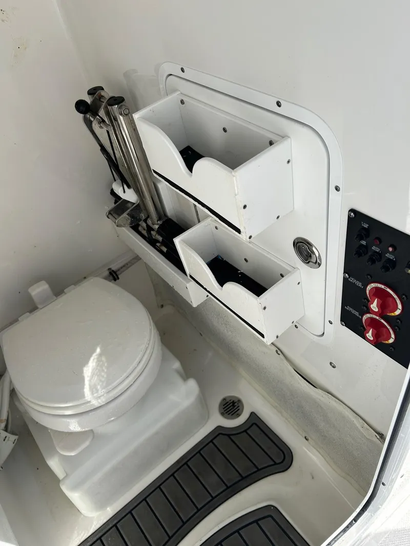 Slide: The Image of 2022 Sea Hunt Gamefish 25 boat interior with toilet and storage compartments. - 16