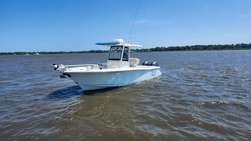 Slide: The Image of 2022 Sea Hunt Gamefish 25 boat on open water under clear blue sky. - 18