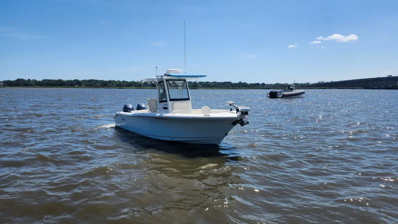 Slide: The Image of 2022 Sea Hunt Gamefish 25 boat on calm water under clear blue sky. - 20