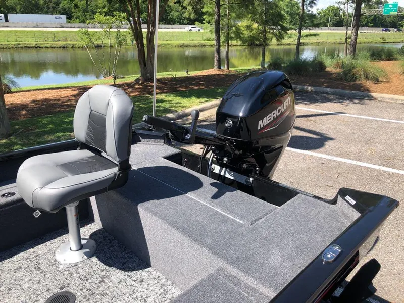 Slide: The Image of 2025 Tracker Super Guide V-16 T boat with Mercury engine, parked near a scenic lake. - 12