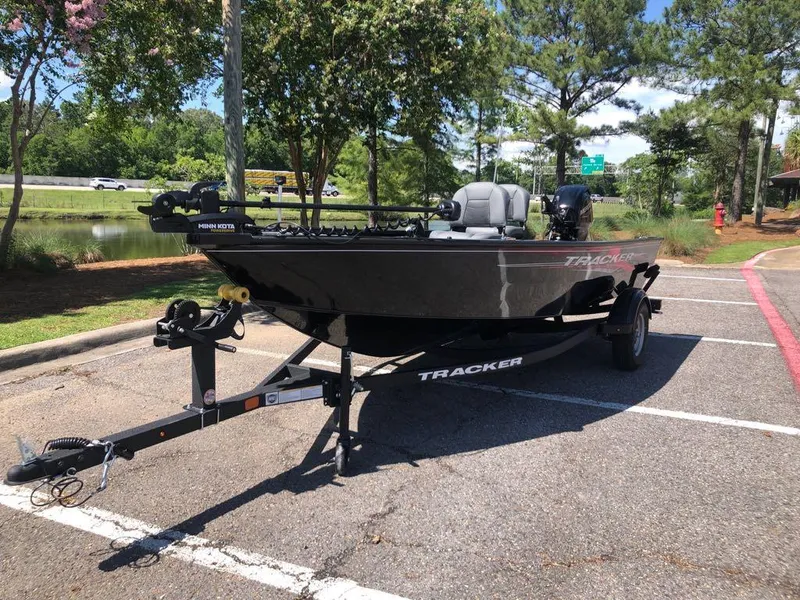Slide: The Image of 2025 Tracker Super Guide V-16 T boat on trailer in parking lot. - 13
