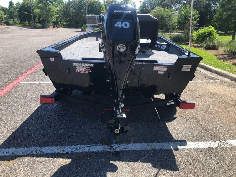 Slide: The Image of 2025 Tracker Super Guide V-16 T boat with Mercury 40 engine in parking lot. - 2