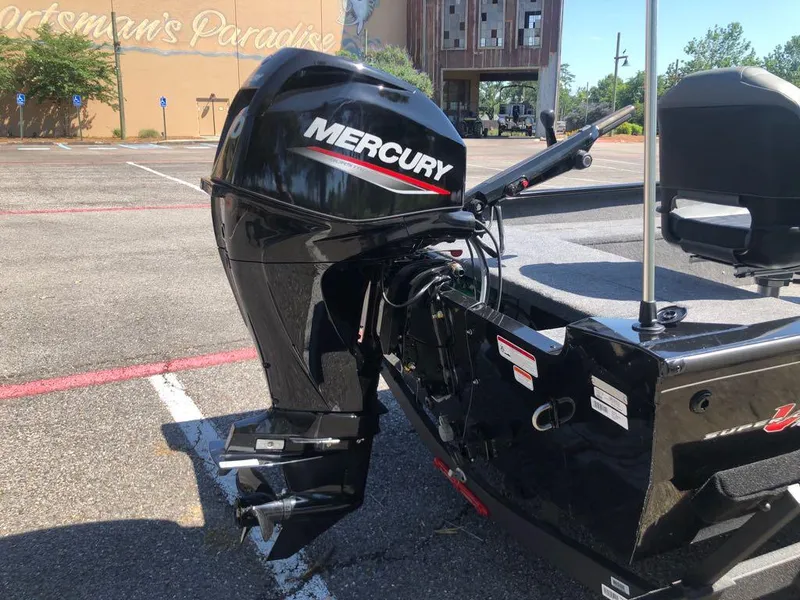 Slide: The Image of 2025 Tracker Super Guide V-16 T boat with Mercury outboard motor in parking lot. - 3