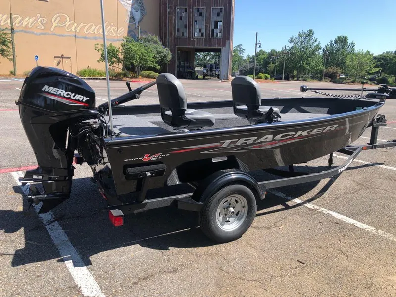 Slide: The Image of 2025 Tracker Super Guide V-16 T boat with Mercury engine in parking lot. - 4
