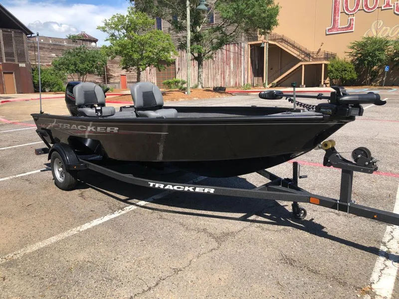 Slide: The Image of 2025 Tracker Super Guide V-16 T boat on trailer in parking lot. - 6