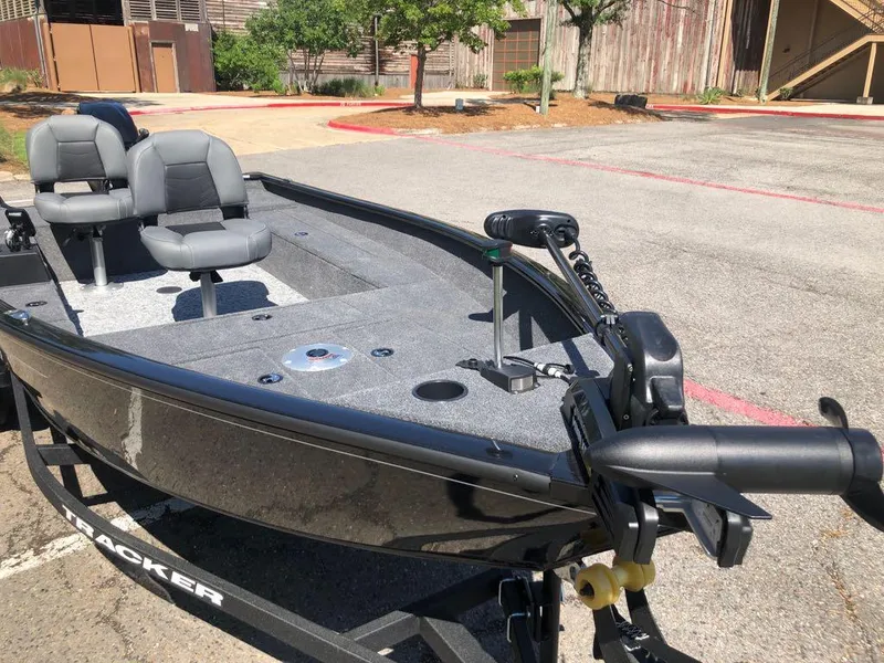 Slide: The Image of 2025 Tracker Super Guide V-16 T fishing boat in a parking lot. - 8