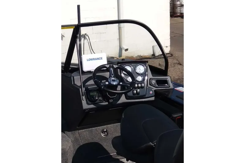 Slide: The Image of 2025 Tracker Targa V-18 WT boat dashboard with steering wheel and Lowrance navigation system. - 28