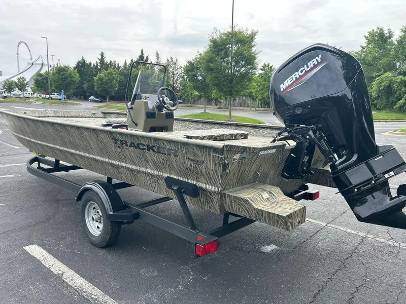 Slide: The Image of 2025 Tracker Grizzly 2072 CC boat with Mercury engine on trailer in parking lot. - 3