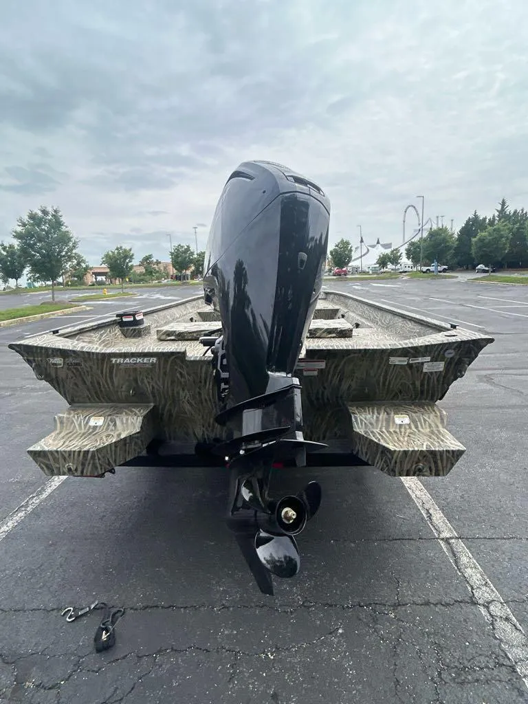 Slide: The Image of 2025 Tracker Grizzly 2072 CC boat with camouflage design in a parking lot. - 4
