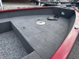 Slide: The Image of 2025 Tracker Super Guide V-16 T boat interior with gray carpet and storage compartments. - 4