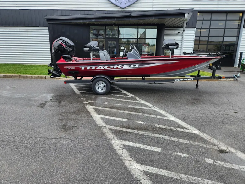 The Image of 2025 Tracker Pro Team 190 boat on trailer, parked outside a building. - 0
