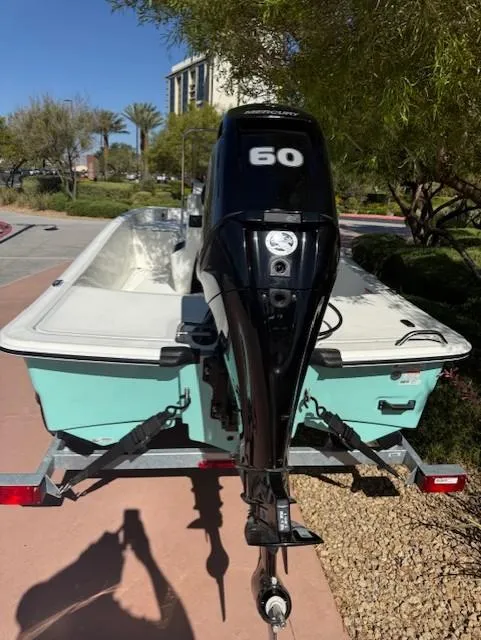 Slide: The Image of 2025 Mako Pro Skiff 15 CC with 60 HP outboard motor on a trailer. - 3