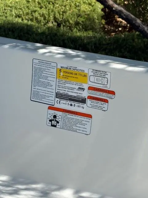 Slide: The Image of 2025 Mako Pro Skiff 15 CC capacity label, showing weight and passenger limits. - 9