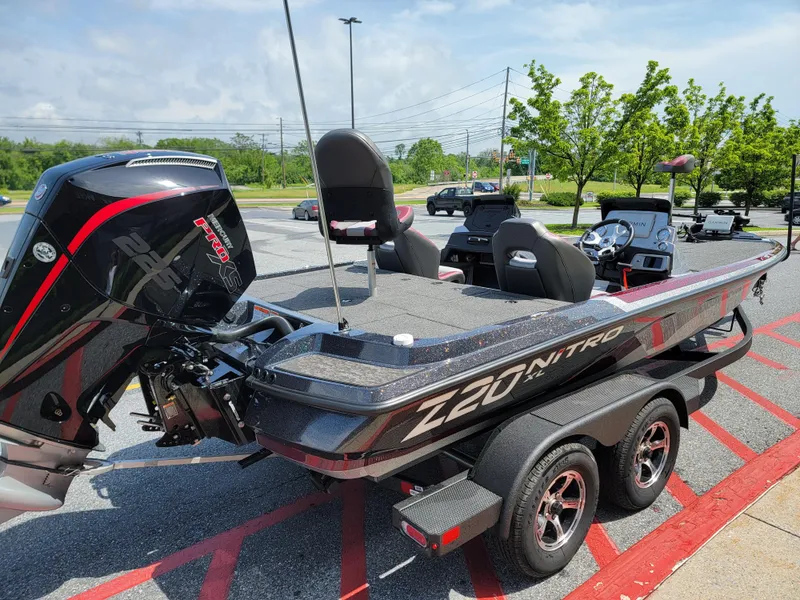 Slide: The Image of 2025 Nitro Z20 XL Pro bass boat on trailer in parking lot. - 3