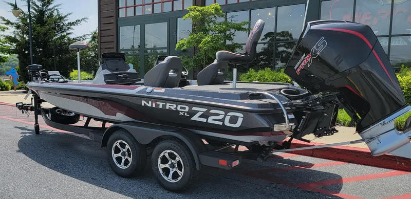 Slide: The Image of 2025 Nitro Z20 XL Pro boat with trailer, parked outdoors on a sunny day. - 4