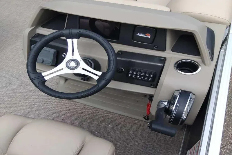 Slide: The Image of 2025 Sun Tracker SportFish 20 DLX dashboard with steering wheel and controls. - 2
