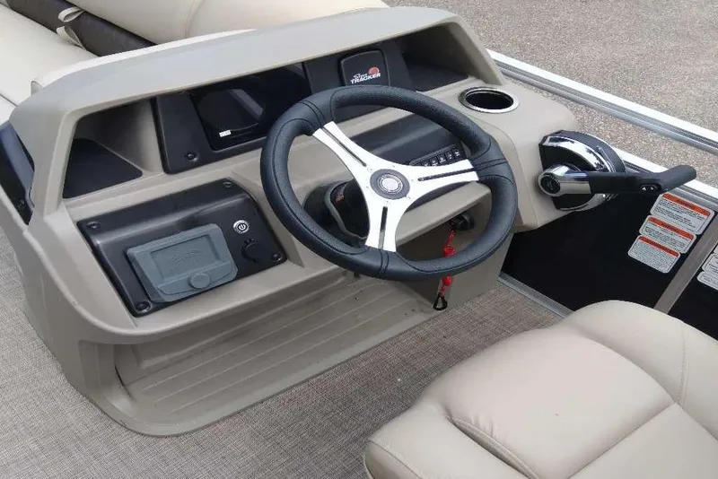 Slide: The Image of 2025 Sun Tracker SportFish 20 DLX boat console with steering wheel and controls. - 3