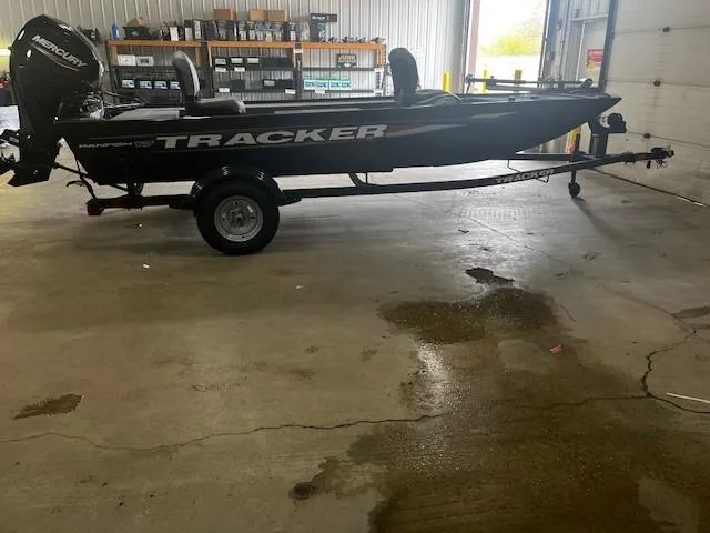 The Image of 2025 Tracker Panfish 17 boat on trailer in a garage setting. - 0